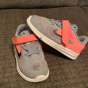 Gray and coral Nike sneakers